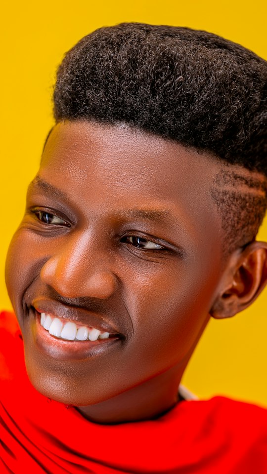 Smiling client with a high top and a hard part