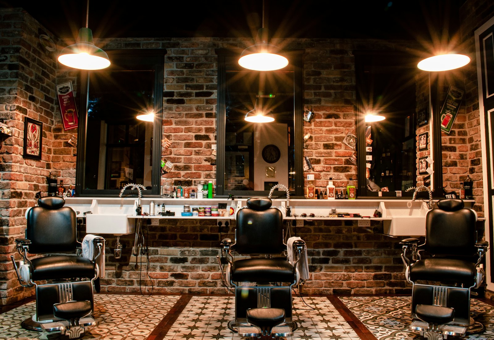 Inside Reinat’s: barber chairs, brick wall and warm pendant lights