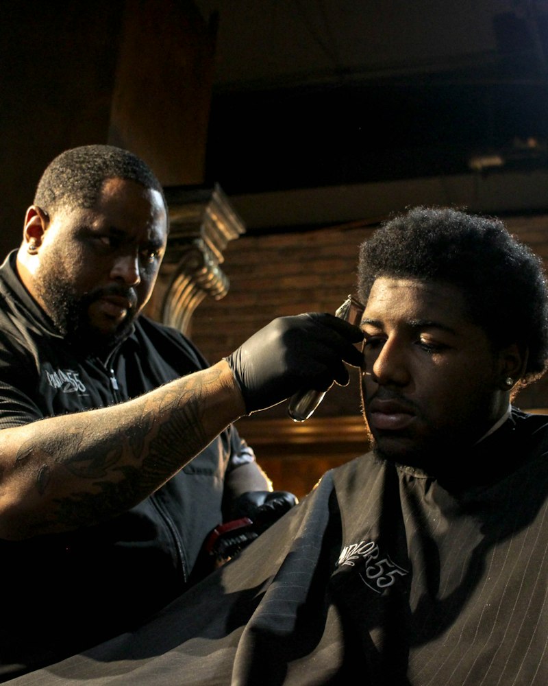 Barber shaping a full beard with scissors